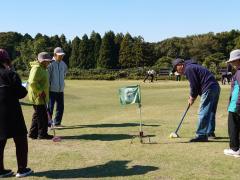 参加者がホールポストを狙ってボールを打っている