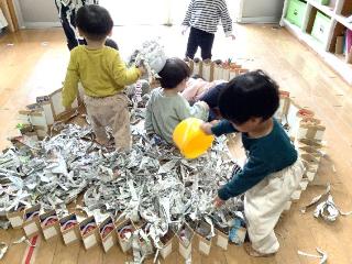 もも組が新聞紙遊びをしています