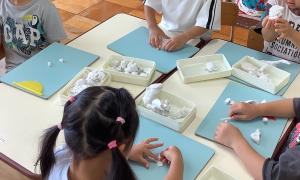 3歳児が粘土でパンを作っています