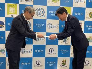 報告書を市長に渡している様子