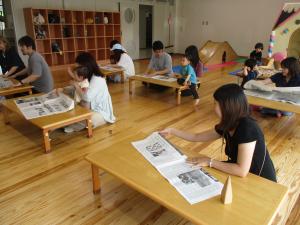 紙袋作りを楽しむ親子たち
