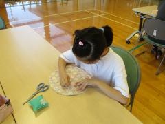 針と糸を使って縫い物を体験しています